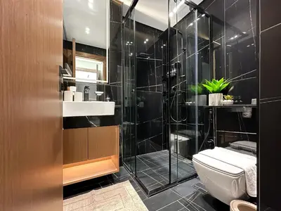 a bathroom with a toilet and a glass shower at Trophy Luxury Stellar Sky Suites in JVC with Great Views in Dubai