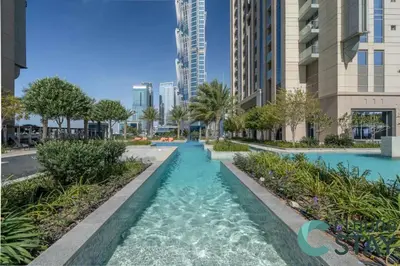 a pool in the middle of a city with tall buildings at Cloud 9 - Luxurious 1 Bedroom Apartment in Business Bay in Dubai