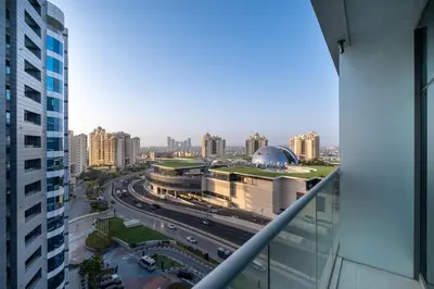 a view of a city with buildings and traffic at Charming Studio in Seven Palm with Balcony Rooftop Floor in Dubai