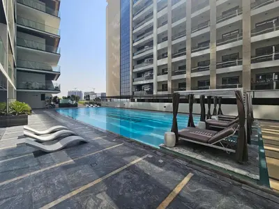 a swimming pool on the roof of a building at Chic 1 Bed in Creek Side with Terrace in Dubai