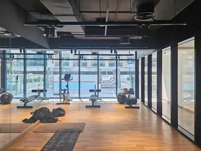 a gym with a lot of treadmills and exercise equipment at Chic 1 Bed in Creek Side with Terrace in Dubai