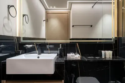a bathroom with a white sink and a mirror at Chic 1 Bed in Creek Side with Terrace in Dubai