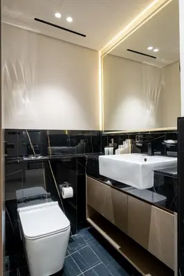a bathroom with a sink and a toilet and a mirror at Chic 1 Bed in Creek Side with Terrace in Dubai