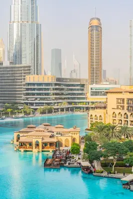 a river with boats in a city with tall buildings at the Byron Bay condo in Dubai