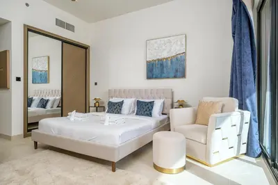 a bedroom with a bed and a couch and a chair at Business Bay Studio Binghatti Canal with Terrace in Dubai