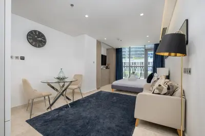 a living room with a bed and a table at Downtown Apartment Studio near Burj Khalifa in Dubai