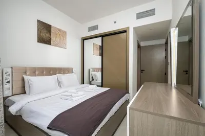 a bedroom with a bed with towels on it at Elegant 1 Bed Apartment in Binghatti Creek in Dubai