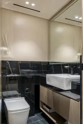a bathroom with a toilet and a sink and a mirror at Elegant 1 Bed Apartment in Binghatti Creek in Dubai