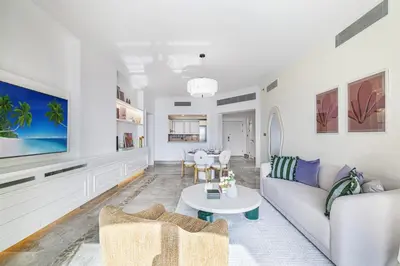 a living room with a couch and a table at Daniels 2BR at Fairmont South The Palm Jumeirah in Dubai