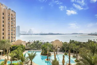 an aerial view of a resort with a large swimming pool at Daniels 2BR at Fairmont South The Palm Jumeirah in Dubai