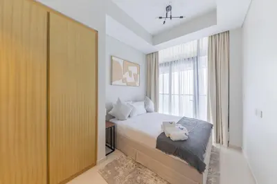 a bedroom with a bed and a large window at Cozy 2BR in Business Bay, Aykon Tower in Dubai
