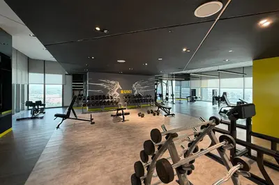 a gym with treadmills and cardio equipment in a building at Cozy 2BR in Business Bay, Aykon Tower in Dubai
