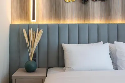 a bedroom with a bed and a vase on a night stand at Luxury apartment in Dubai center, District One in Dubai
