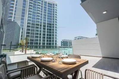 a table on a balcony with a view of a building at Luxury apartment in Dubai center, District One in Dubai