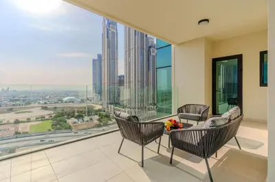a living room with a table and chairs and a large window at DAYF-DAN Missoni Apartment with Private Lift in Business Bay in Dubai