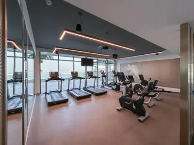 a gym with treadmills and cardio equipment in a building at Stunning Beachfront Home with Panoramic Sea Views in Dubai