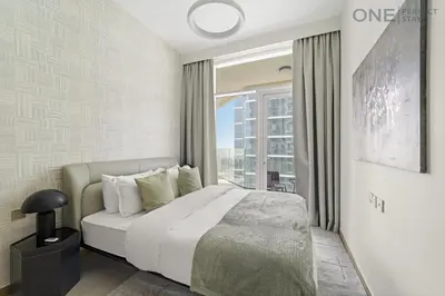 a bedroom with a bed and a large window at Stylish 2BR in Business Bay canal View Pool & Gym in Dubai