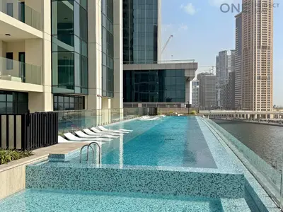a swimming pool on the roof of a building at Stylish 2BR in Business Bay canal View Pool & Gym in Dubai