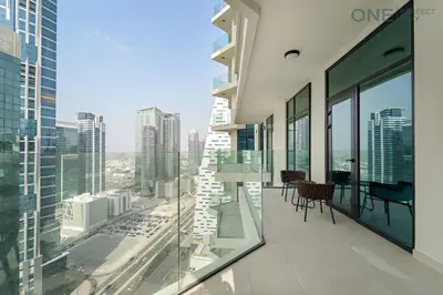 an apartment balcony with a view of the city at Stylish 2BR in Business Bay canal View Pool & Gym in Dubai