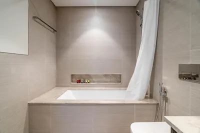 a bathroom with a tub and a toilet and a sink at GuestReady - Burj Khalifa View l Infinity Pool in Dubai