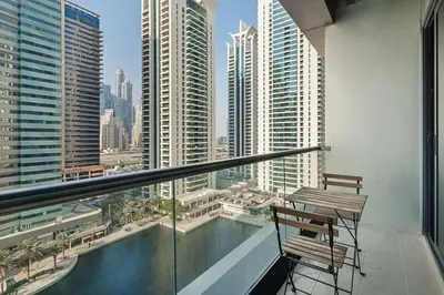 a balcony with a bench and a view of a city at Luxury JLT Studio Lake View Metro & Marina in Dubai