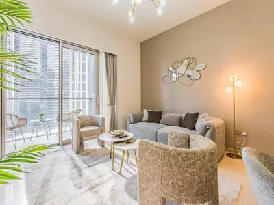 a living room with a couch and a table at 2 BR - Grande Signature - Burj Khalifa View in Dubai
