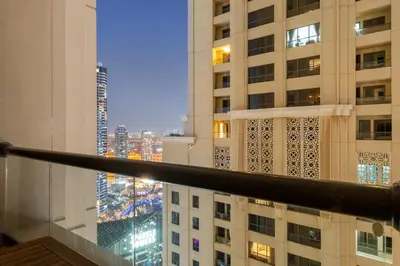 a view from the balcony of a building at night at Elegant 2BR with Seaview in JBR l Walk to the Beach in Dubai