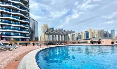 a large swimming pool with a city skyline in the background at Elegant Studio in Marina near Beach and Metro Z1113 in Dubai