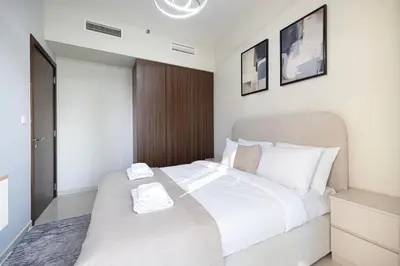 a bedroom with a bed with two towels on it at Exclusive 1-Bedroom Apartment with Breathtaking Burj Khalifa Views in the Heart of Dubai in Dubai