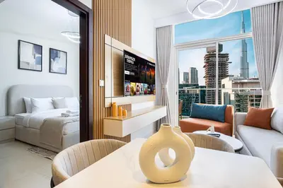 a living room with a bed and a living room with a couch at Exclusive 1-Bedroom Apartment with Breathtaking Burj Khalifa Views in the Heart of Dubai in Dubai