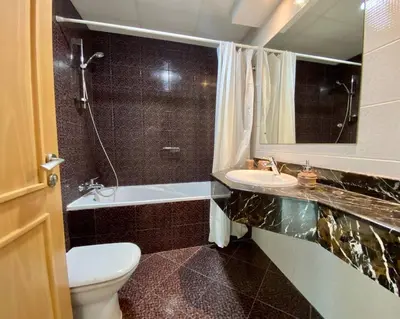 a bathroom with a toilet and a sink and a tub at Cozy 1 Bedroom Apartment with Marina and Sea View Z1306 in Dubai
