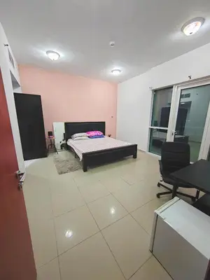 a bedroom with a bed and a table and chairs at Private Master Room Marina Beach next to Marriott in Dubai