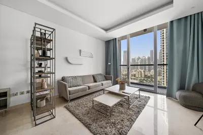 a living room with a couch and a table at Luxury Living in Sterling West in Dubai