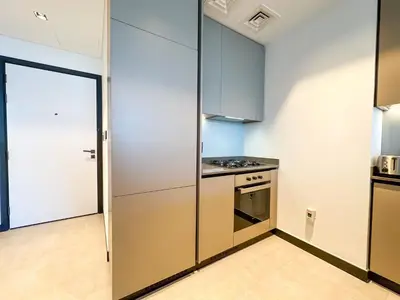 a kitchen with stainless steel appliances and a door at Luxury 1BR in 15 Northside Tower with Canal View 4AB03 in Dubai