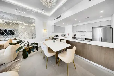 a kitchen and living room with a table and chairs at Forte Tower 1 by Emaar - Dubai Fountain View, Downtown Dubai in Dubai