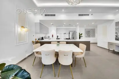 a kitchen and dining room with a white table and chairs at Forte Tower 1 by Emaar - Dubai Fountain View, Downtown Dubai in Dubai