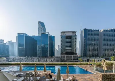 a view of a pool in a city with buildings at Luxury Apartment with Balcony & Full Burj Khalifa View by Dejaview Stays in Dubai
