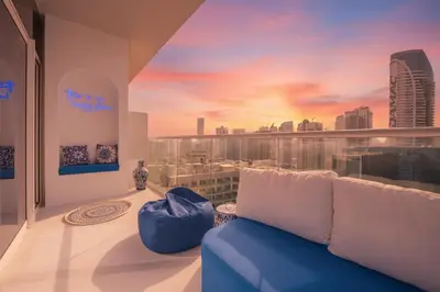 a living room with a couch and a view of a city at Luxury Apartment with Balcony & Full Burj Khalifa View by Dejaview Stays in Dubai