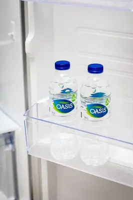 three bottles of water sitting on a shelf in a refrigerator at City Walk Green Planet View 1Br in Dubai
