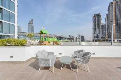 a patio with chairs and a table and a playground at STAY BY LATINEM Luxury 1BR Holiday Home W706 Near Burj Khalifa in Dubai