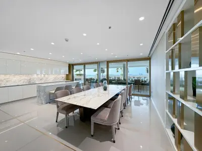 a dining room with a long table and chairs at Seaview Living 2 Bedroom - Grand Bleu by Elie Saab in Dubai