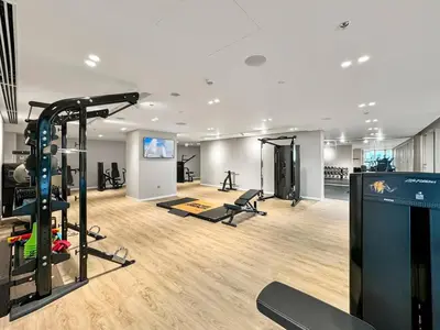 a gym with treadmills and exercise equipment in a room at Seaview Living 2 Bedroom - Grand Bleu by Elie Saab in Dubai