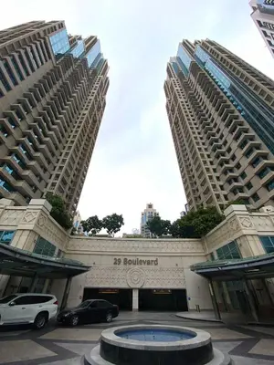 two large buildings with cars parked in a parking lot at Silkhaus Modern Studio with Burj Khalifa View in Dubai