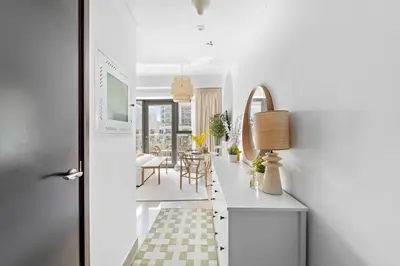 a hallway with a table and a dining room at Silkhaus Modern Studio with Burj Khalifa View in Dubai
