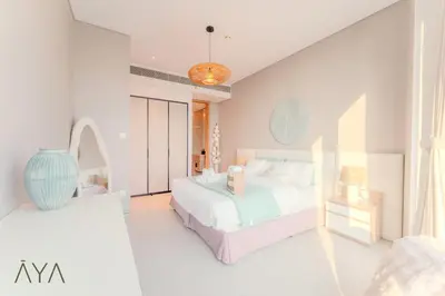 two beds in a room with white walls at Luxury Beachfront 1BR Jumeirah Gate Tower 1 By ĀYA Boutique in Dubai