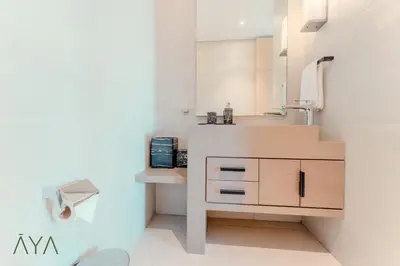 a bathroom with a sink and a toilet in a room at Luxury Beachfront 1BR Jumeirah Gate Tower 1 By ĀYA Boutique in Dubai