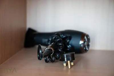 a group of black objects on a wooden table at Luxury Beachfront 1BR Jumeirah Gate Tower 1 By ĀYA Boutique in Dubai