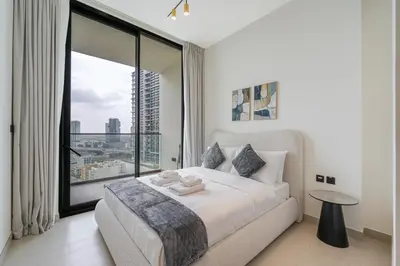 a bedroom with a bed and a large window at Smart living I High speed wi-fi I City view in Dubai