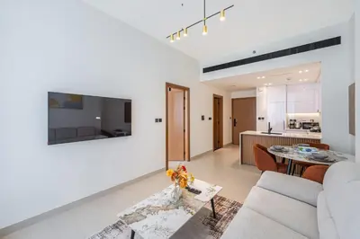 a living room with a couch and a table at Smart living I High speed wi-fi I City view in Dubai