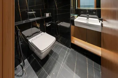 a bathroom with a white toilet and two sinks at Smart living I High speed wi-fi I City view in Dubai